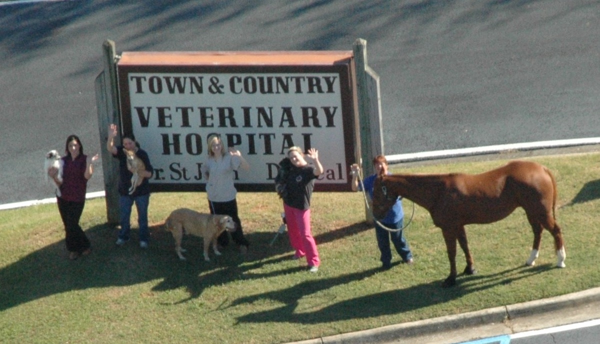 staff in front of sign